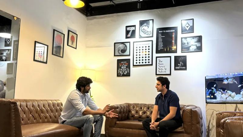 Two Salsoft colleagues in conversation in the Karachi office lounge.